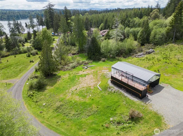 a view of a backyard with plants and lake view