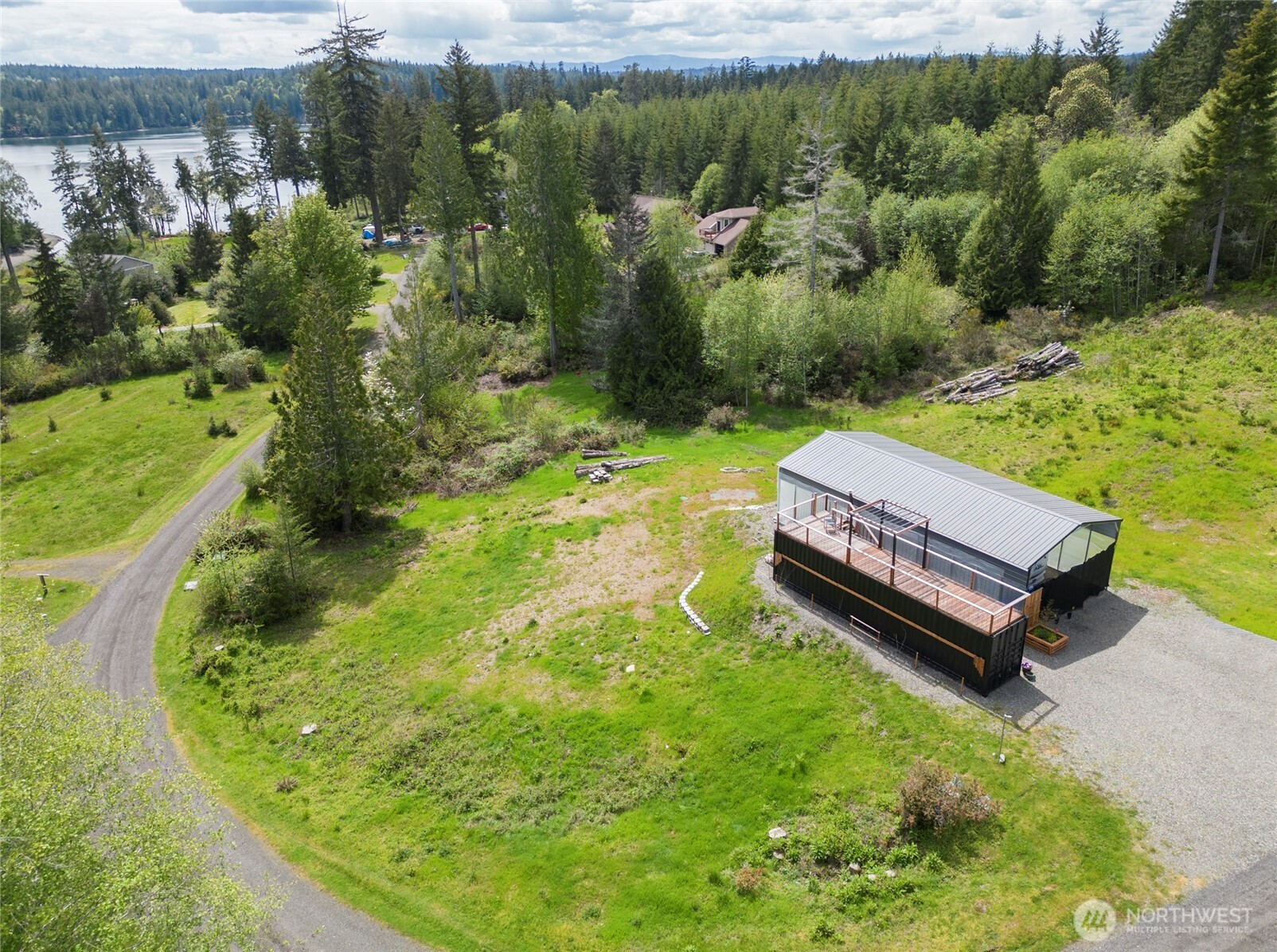 770 East April Avenue Grapeview, WA 98546 - Photo 2 of 21 a view of a backyard with plants and lake view