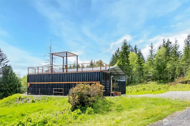 a view of a chair and table with wooden fence