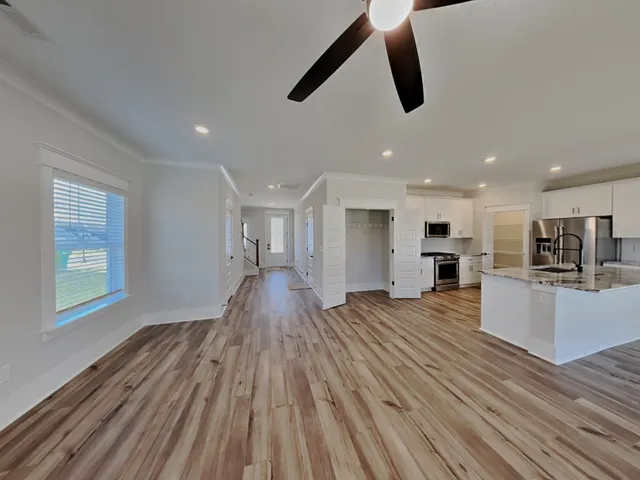 a view of kitchen and sink with wooden floor