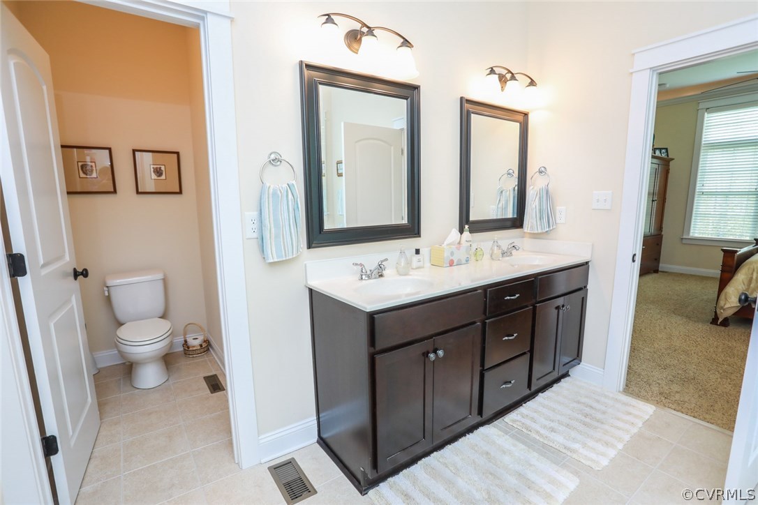 11512 Barrows Ridge Lane Chesterfield, VA 23838 - Photo 33 of 45 a bathroom with a double vanity sink mirror and toilet