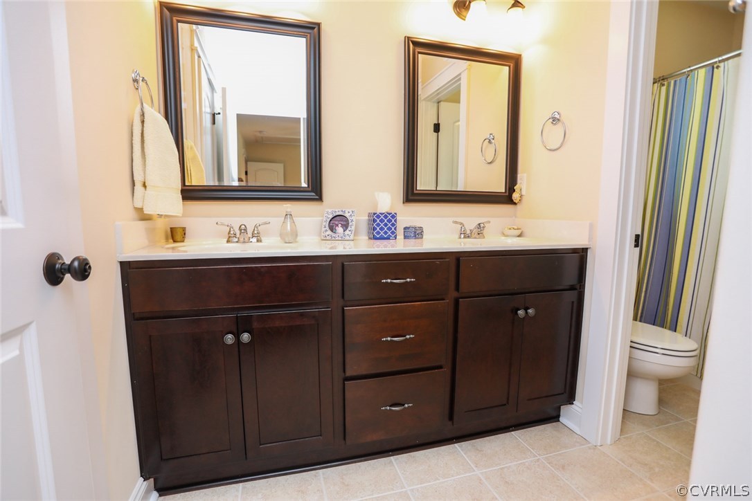 11512 Barrows Ridge Lane Chesterfield, VA 23838 - Photo 35 of 45 a bathroom with a double vanity sink and a mirror