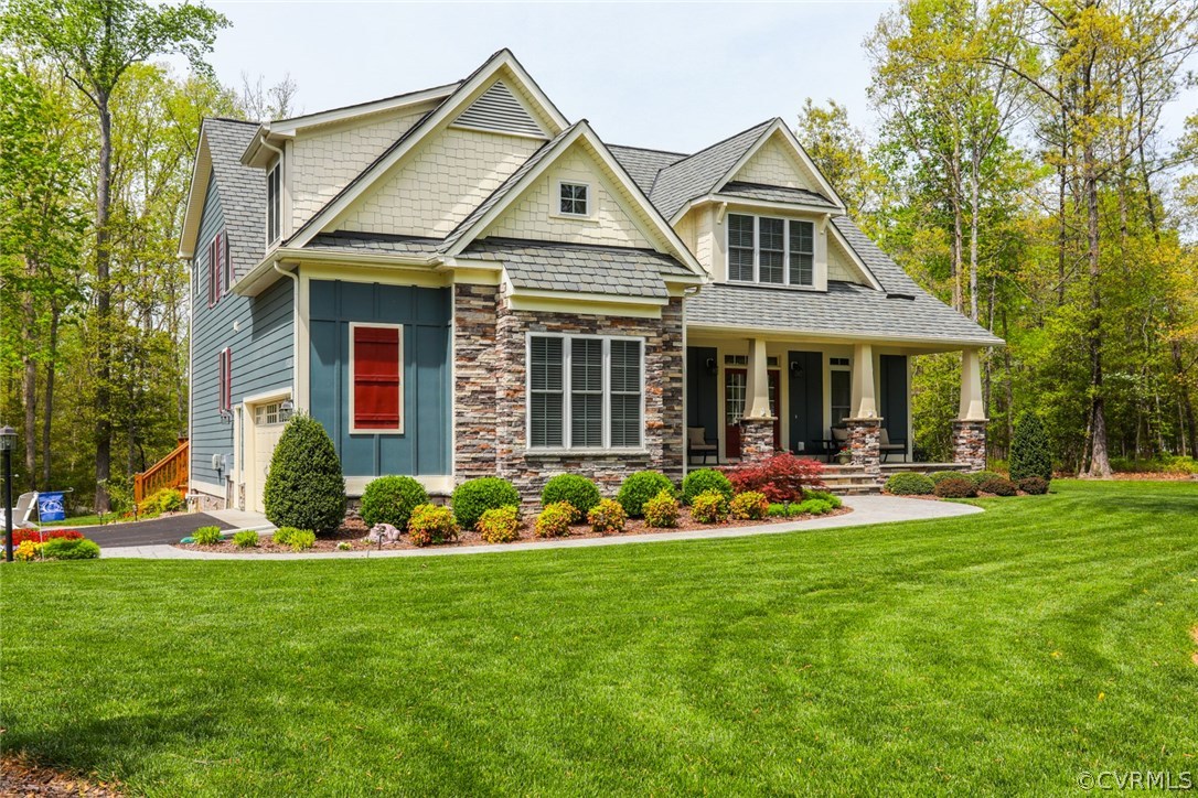 11512 Barrows Ridge Lane Chesterfield, VA 23838 - Photo 4 of 45 a front view of a house with a garden and plants
