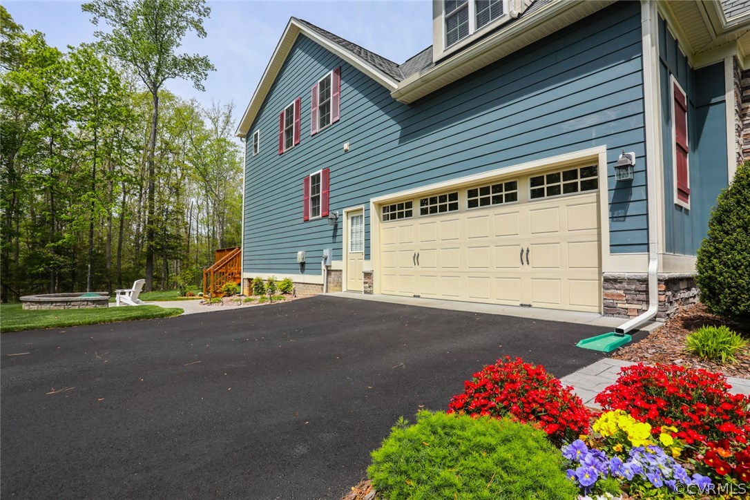 11512 Barrows Ridge Lane Chesterfield, VA 23838 - Photo 42 of 45 a front view of a house with a yard and garage