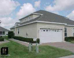 a view of backyard with table and chairs and potted plants