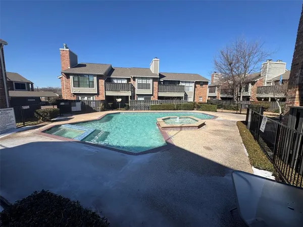 a view of a swimming pool with an outdoor seating