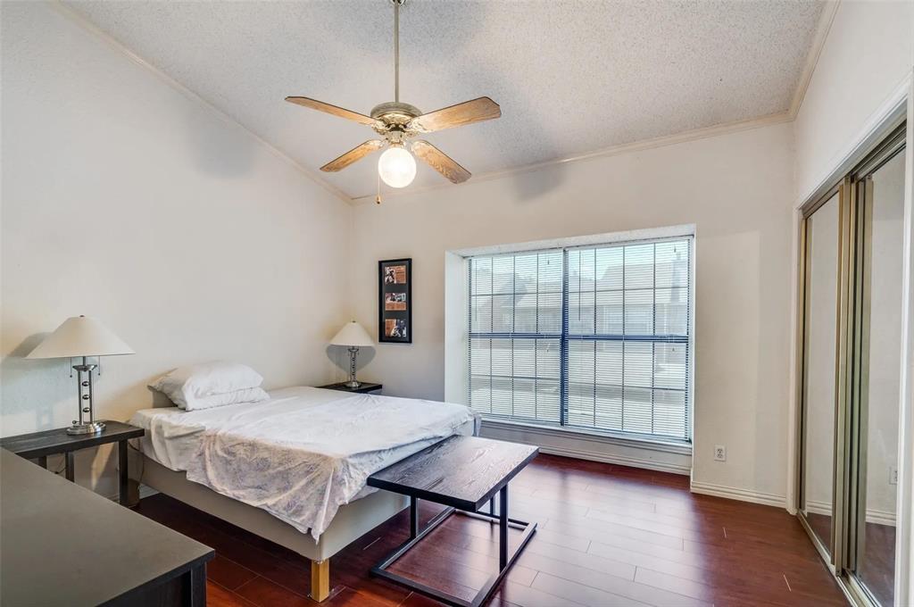 401 Pebble Way, Unit 237 Arlington, TX 76006 - Photo 6 of 12 a bedroom with a bed and wooden floor