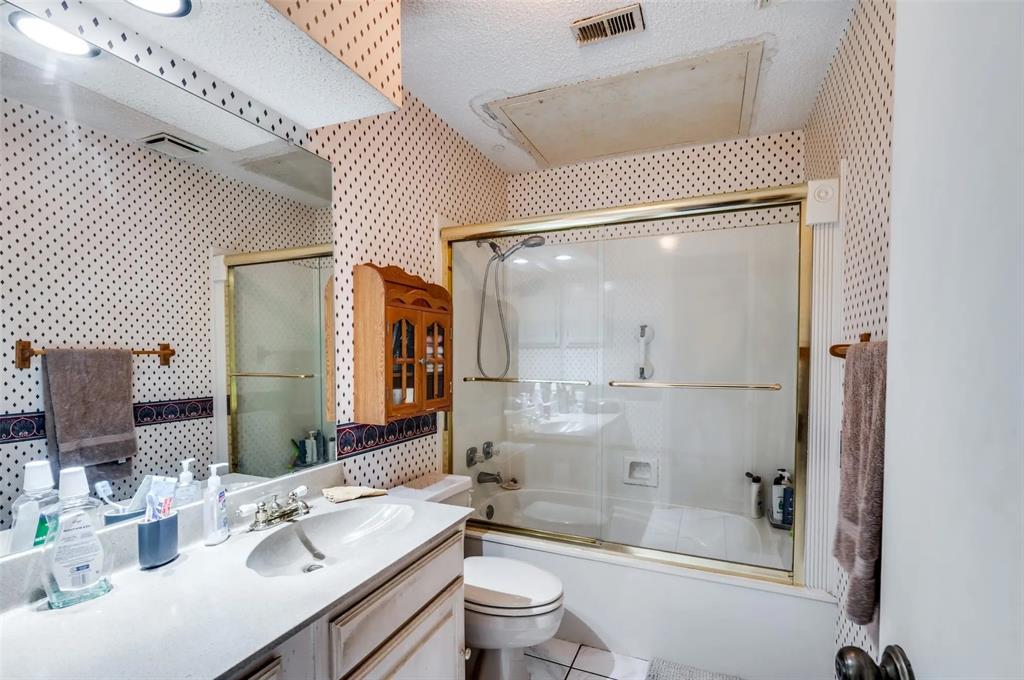 401 Pebble Way, Unit 237 Arlington, TX 76006 - Photo 7 of 12 a bathroom with a sink a toilet and shower