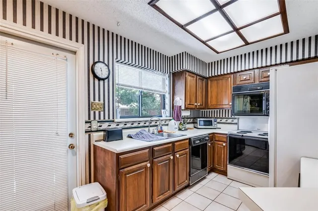 a kitchen with a sink stove and cabinets