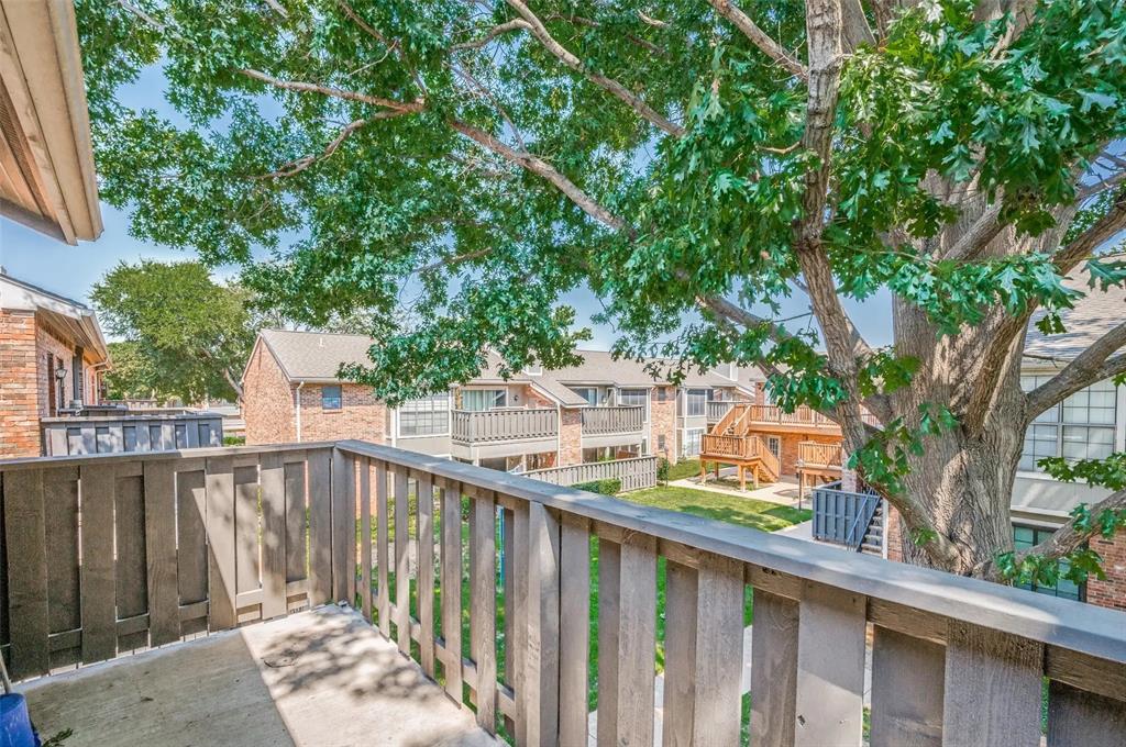 401 Pebble Way, Unit 237 Arlington, TX 76006 - Photo 9 of 12 a view of a balcony with wooden fence and floor