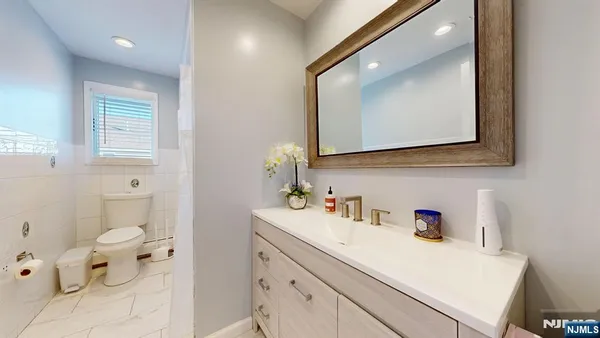 a bathroom with a sink vanity and a mirror