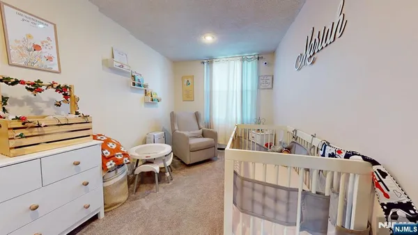 a room with furniture a baby crib and a window