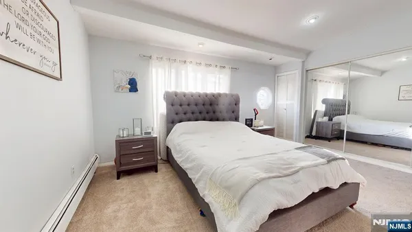 a bedroom with bed and a window
