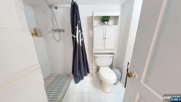 a white toilet sitting next to a sink
