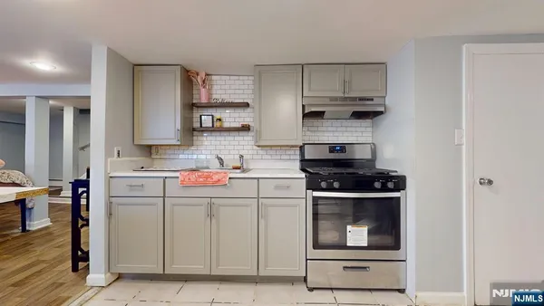 a kitchen with stainless steel appliances granite countertop a stove and a refrigerator
