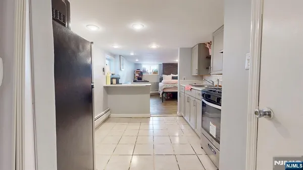 a kitchen with stainless steel appliances a refrigerator sink and cabinets