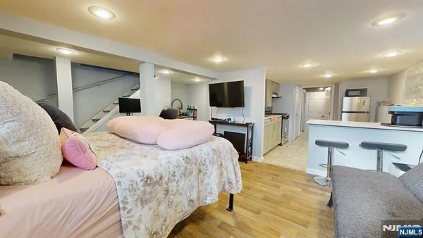 a bedroom with a large bed and a flat screen tv