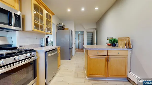 a kitchen with stainless steel appliances a stove and a refrigerator