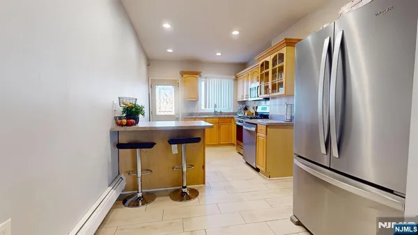 a kitchen with stainless steel appliances granite countertop a refrigerator and a stove