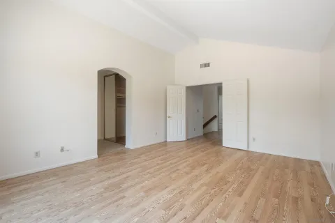 a view of empty room with wooden floor