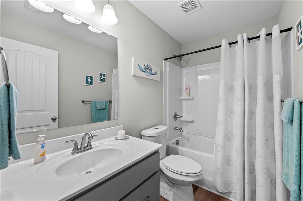 230 Augusta Walk Canton, GA 30114 - Photo 40 of 56 a bathroom with a sink toilet a mirror a vanity and shower