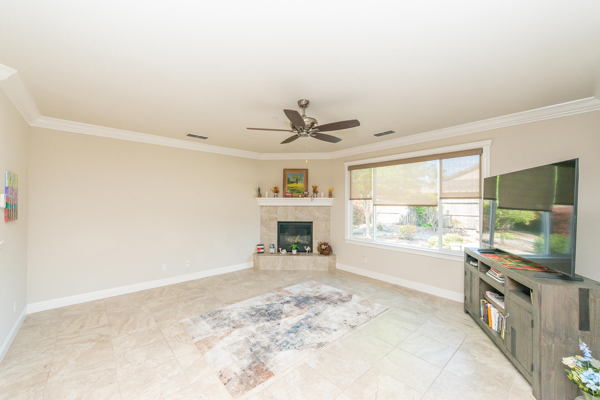 3326 Hotlam Road Redding, CA 96002 - Photo 11 of 60 a view of a livingroom with a fireplace a microwave and a large window