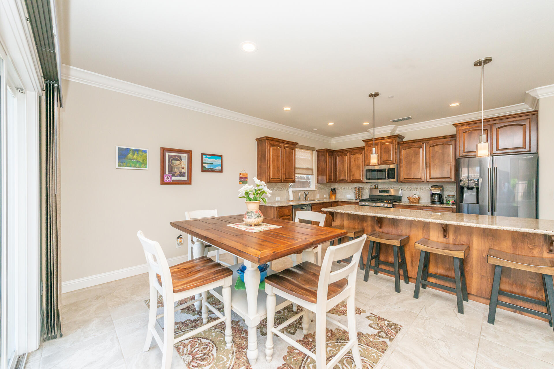 3326 Hotlam Road Redding, CA 96002 - Photo 20 of 60 a kitchen with a dining table chairs and refrigerator