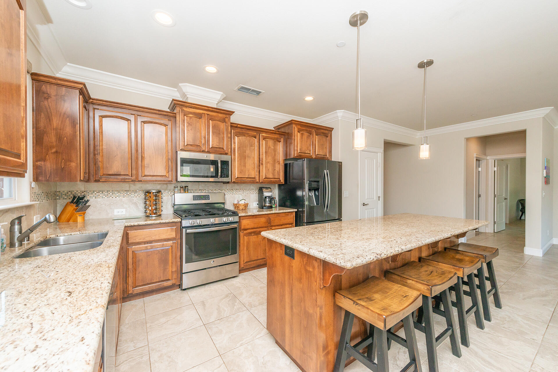 3326 Hotlam Road Redding, CA 96002 - Photo 25 of 60 a kitchen with stainless steel appliances granite countertop a stove refrigerator sink and cabinets