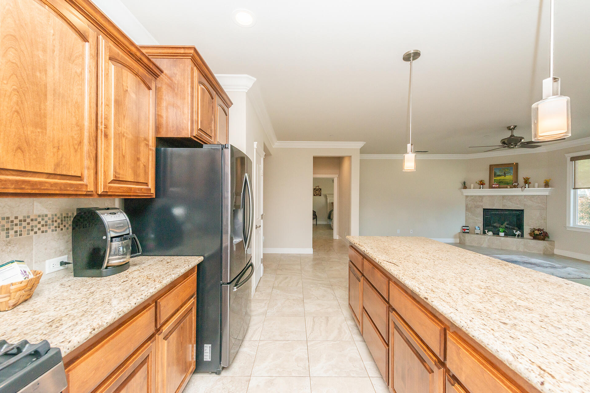 3326 Hotlam Road Redding, CA 96002 - Photo 27 of 60 a kitchen with kitchen island granite countertop a sink a counter and refrigerator