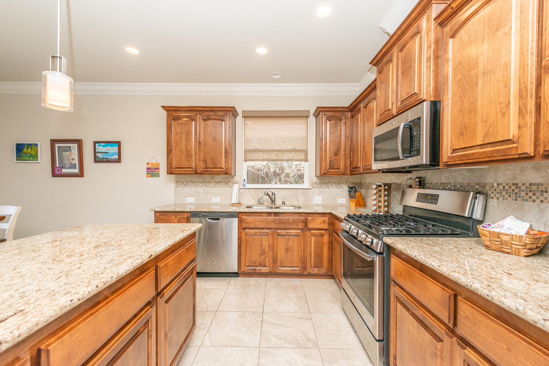 3326 Hotlam Road Redding, CA 96002 - Photo 28 of 60 a kitchen with stainless steel appliances granite countertop a sink and dishwasher a stove top oven with wooden floor