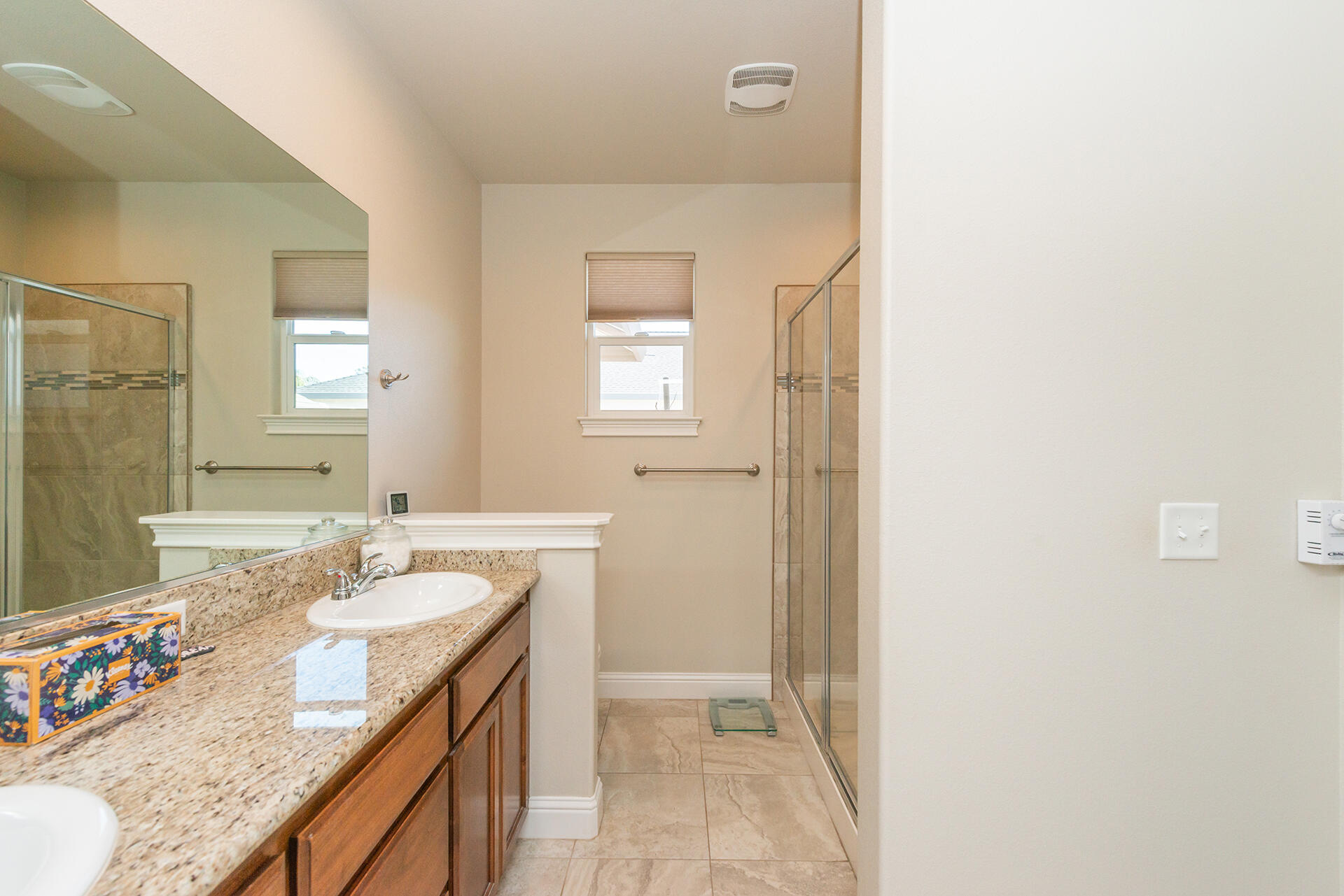 3326 Hotlam Road Redding, CA 96002 - Photo 33 of 60 a bathroom with a granite countertop sink a mirror and a