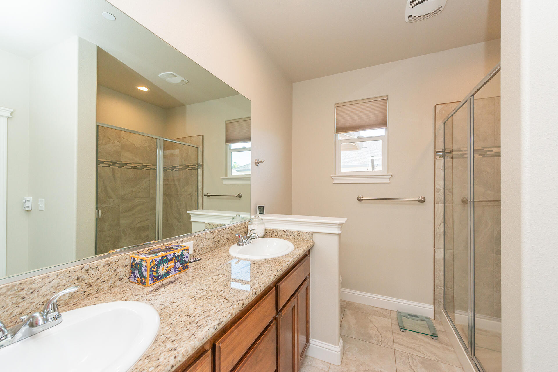 3326 Hotlam Road Redding, CA 96002 - Photo 34 of 60 a bathroom with a granite countertop sink a mirror and a shower