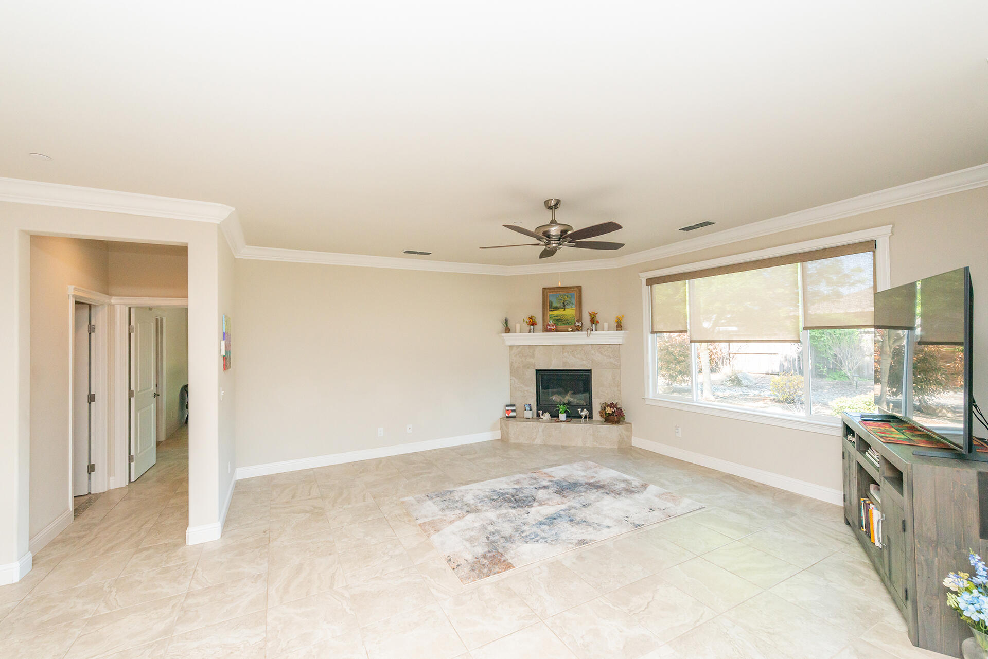 3326 Hotlam Road Redding, CA 96002 - Photo 10 of 60 a view of an empty room with a fireplace and a window