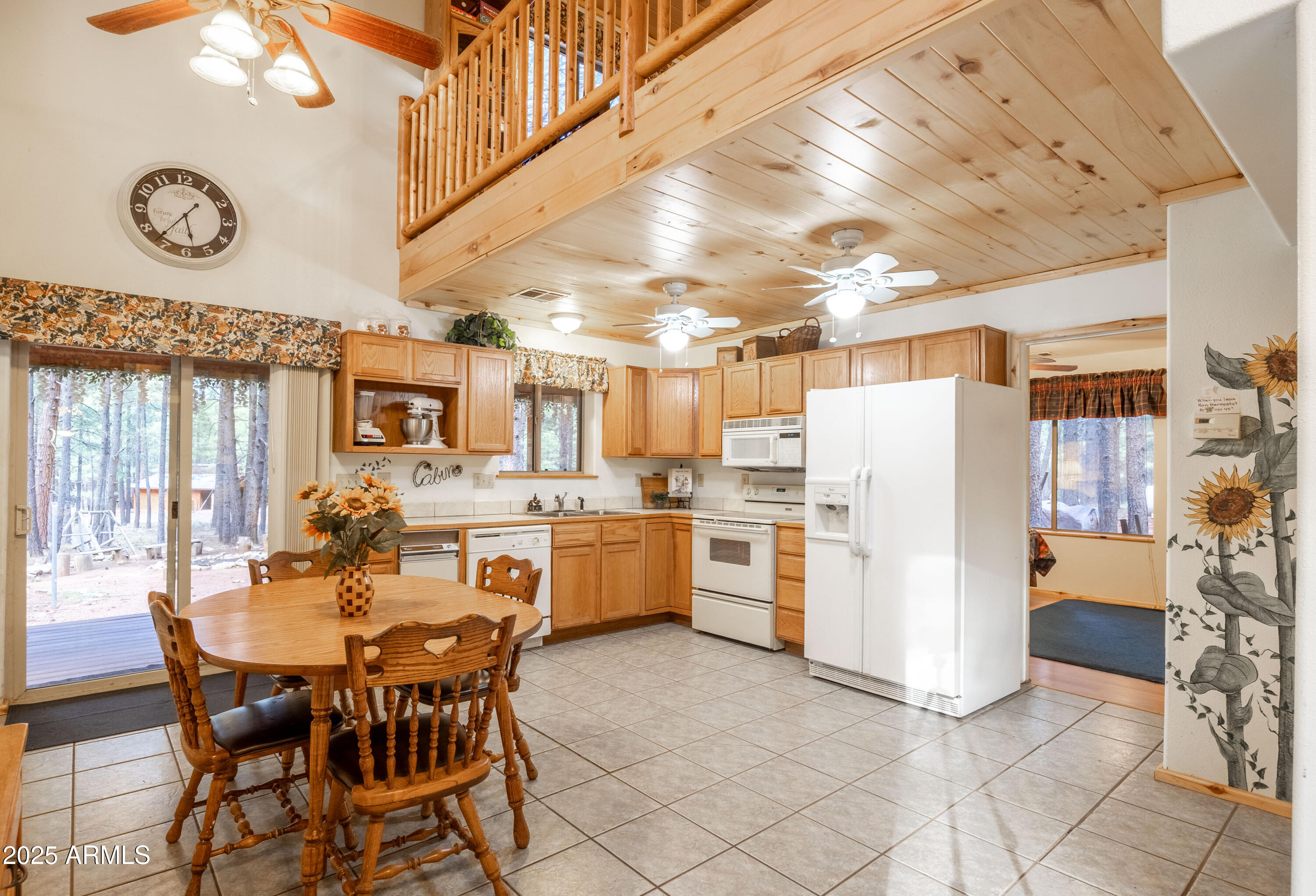 1643 Rifle Way Forest Lakes, AZ 85931 - Photo 7 of 40 a dining hall with stainless steel appliances kitchen island granite countertop a dining table chairs and a refrigerator