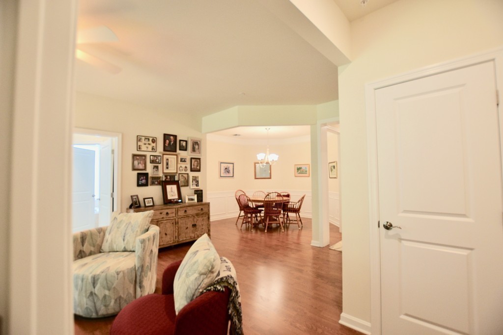 7 Augustus Court, Unit 1013 Reading, MA 01867 - Photo 15 of 34 a living room with furniture and a dining table with wooden floor