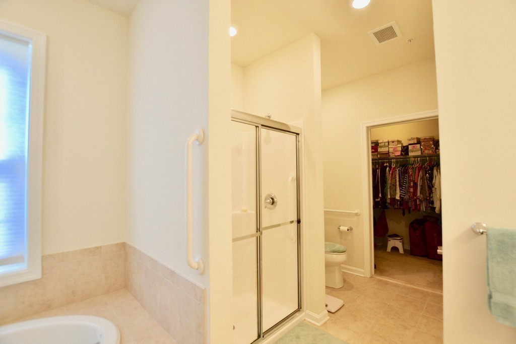 7 Augustus Court, Unit 1013 Reading, MA 01867 - Photo 20 of 34 a bathroom with a shower and a glass door