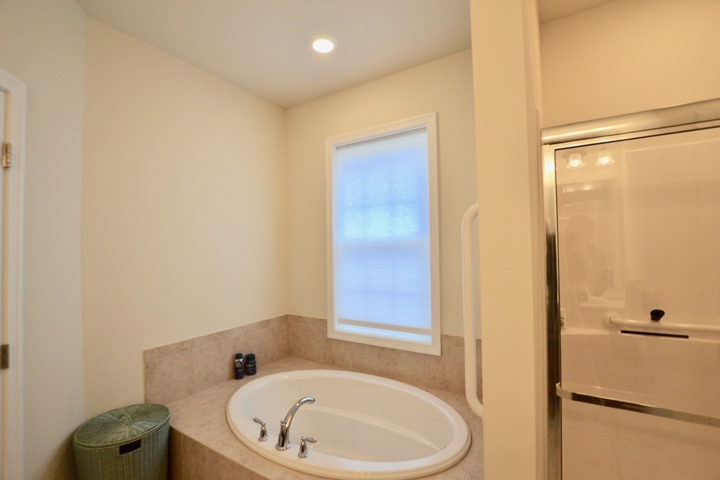 7 Augustus Court, Unit 1013 Reading, MA 01867 - Photo 22 of 34 a bathroom with a tub and shower