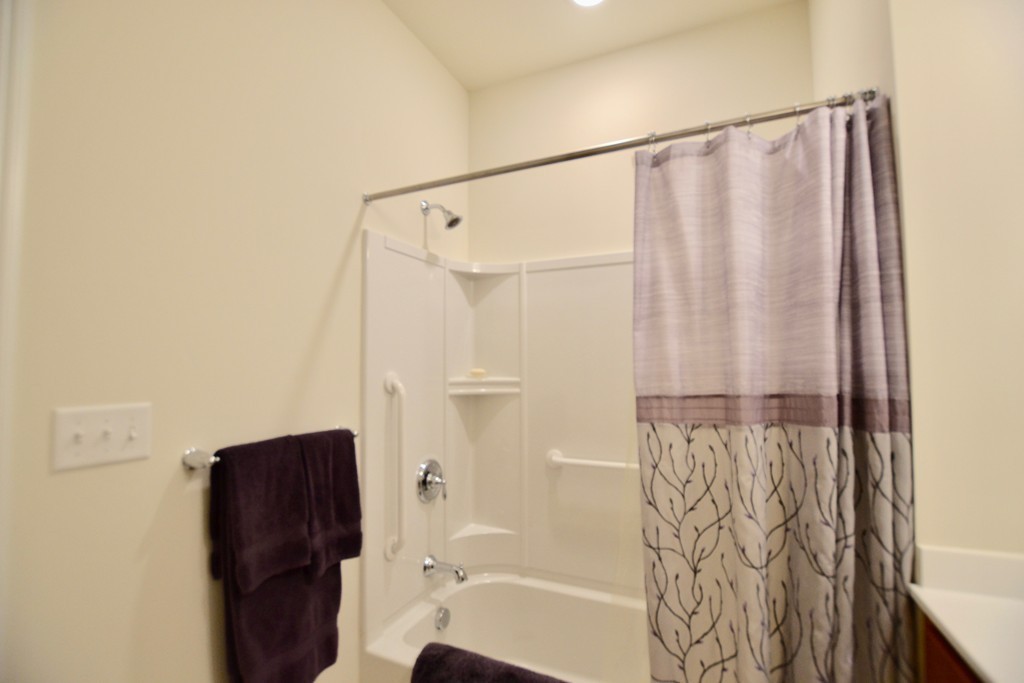 7 Augustus Court, Unit 1013 Reading, MA 01867 - Photo 25 of 34 a bathroom with a shower curtain and a curtain
