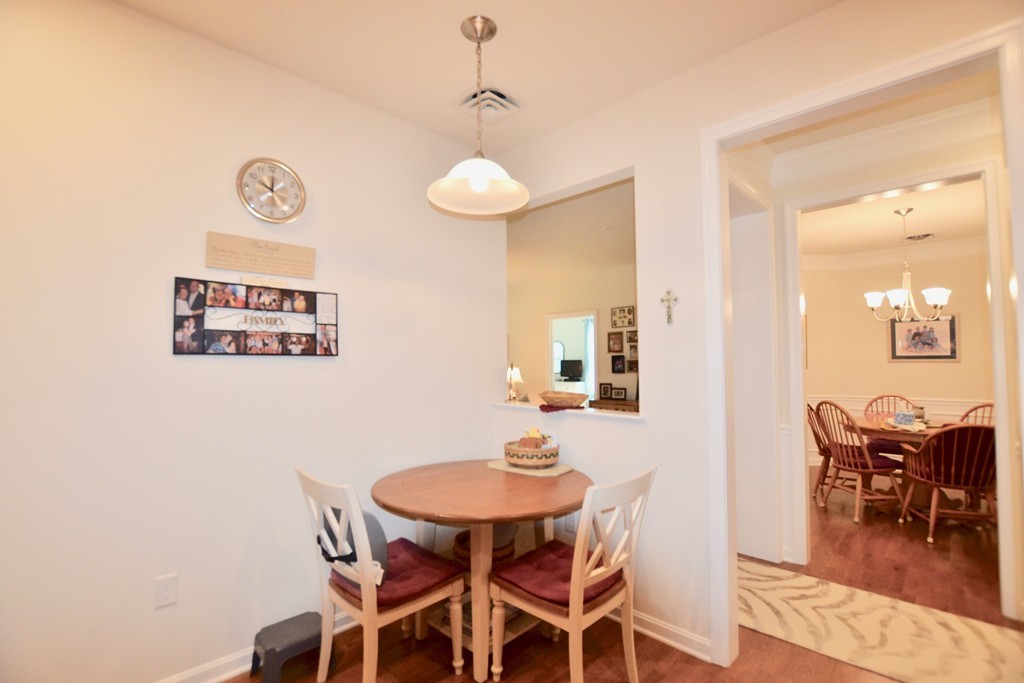 7 Augustus Court, Unit 1013 Reading, MA 01867 - Photo 8 of 34 a view of a dining room with furniture and wooden floor