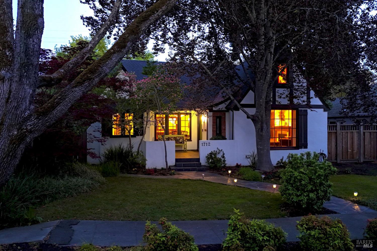 a front view of a house with garden