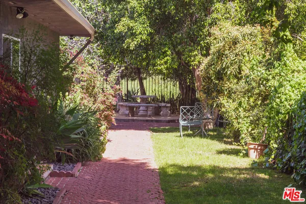 a swimming pool with outdoor seating and yard