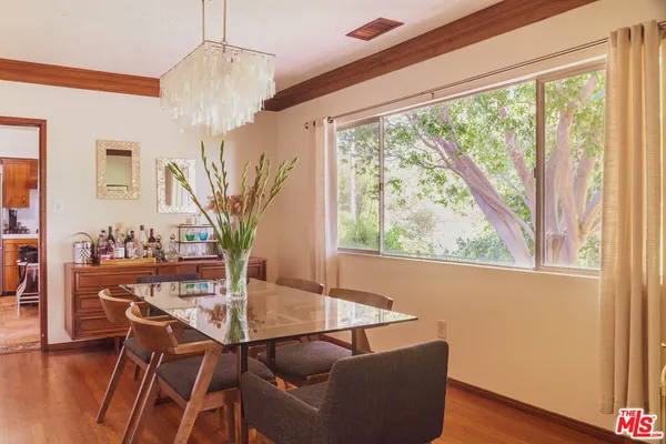 a dining room with furniture and wooden floor