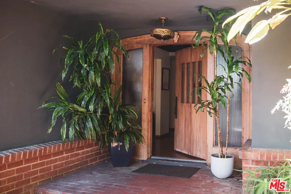 a view of a fountain in the patio in front of a house