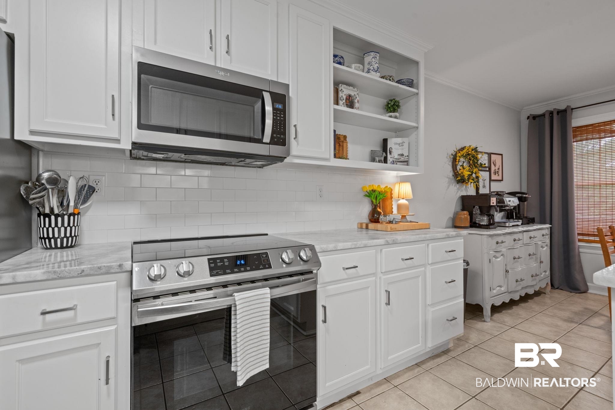 5936 Lundy Road Theodore, AL 36582 - Photo 9 of 32 Kitchen featuring white shaker-style cabinetry, stainless steel appliances, a subway tile backsplash, and light-toned countertops