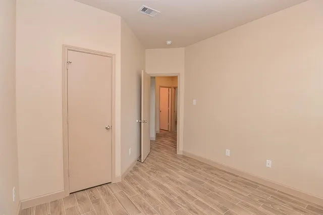 a view of hallway with wooden floor