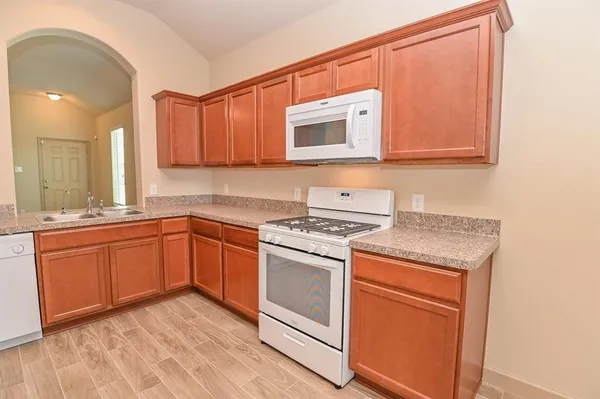 a kitchen with stainless steel appliances granite countertop a stove and a microwave