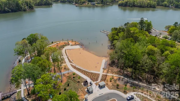an aerial view of a house with a lake view