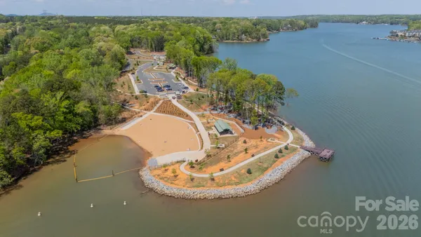 an aerial view of a house with a yard lake house and outdoor seating