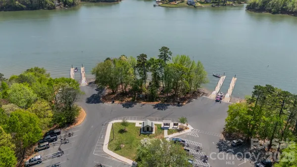 an aerial view of a house with a yard and lake view