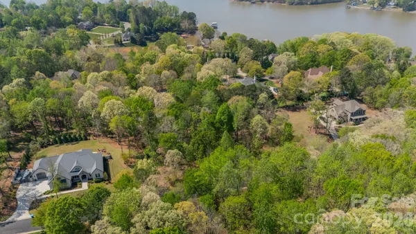 an aerial view of a house with a lake view